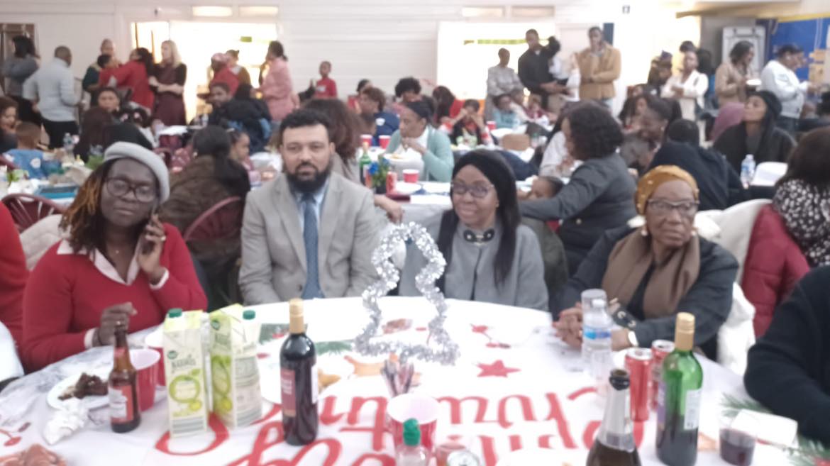 Community gathering around a shared table during a UARU event